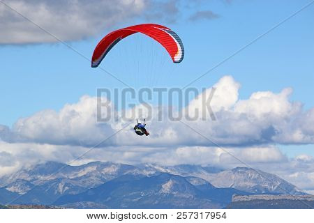 Paraglider Flying His Wing In The French Alps