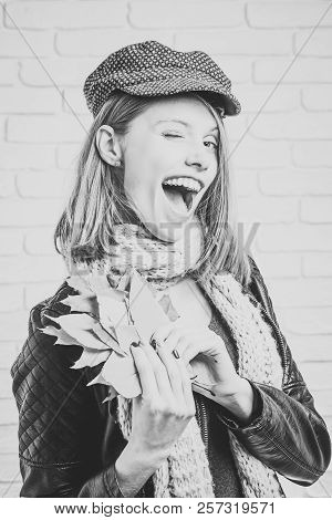 Season And Autumn Holiday. Girl With Orange Leaves At Brick Wall. Woman With Autumn Leaves In Leathe