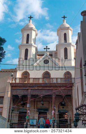 Facade Of A Small Coptic Church With A Wooden Column Porch In The Christian Quarter Of Cairo With Tw