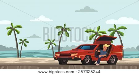 Young Smiling Guy Sitting In Red Race Car On Tropical Beach Background. Traveler In The Natural Envi