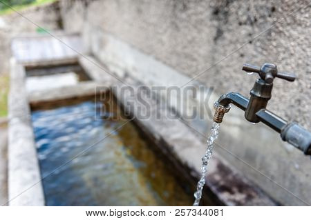 A Tap From A Drinking Water Fountain In The Village Of Santa Fosca, In The Italian Dolomites On A Su