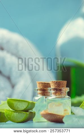Aloe Vera Extract In A Small Bottle And Pieces On The Table. Selective Focus.
