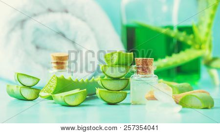 Aloe Vera Extract In A Small Bottle And Pieces On The Table. Selective Focus.