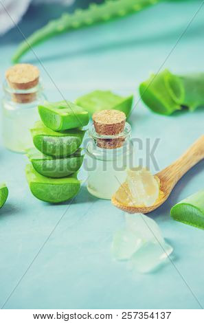 Aloe Vera Extract In A Small Bottle And Pieces On The Table. Selective Focus.