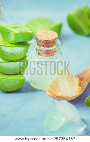 Aloe Vera Extract In A Small Bottle And Pieces On The Table. Selective Focus.