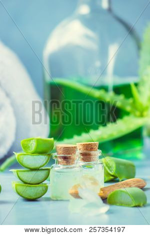 Aloe Vera Extract In A Small Bottle And Pieces On The Table. Selective Focus.