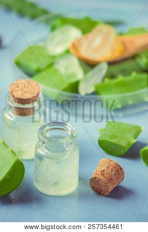 Aloe Vera Extract In A Small Bottle And Pieces On The Table. Selective Focus.