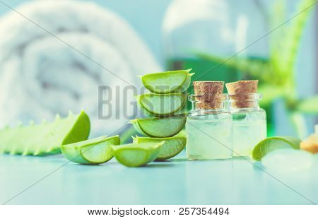 Aloe Vera Extract In A Small Bottle And Pieces On The Table. Selective Focus.