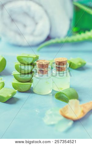 Aloe Vera Extract In A Small Bottle And Pieces On The Table. Selective Focus.