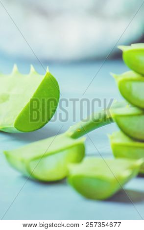Aloe Vera Extract In A Small Bottle And Pieces On The Table. Selective Focus.