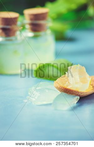 Aloe Vera Extract In A Small Bottle And Pieces On The Table. Selective Focus.