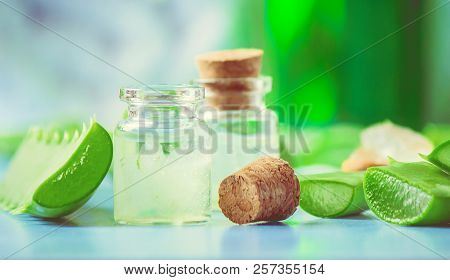 Aloe Vera Extract In A Small Bottle And Pieces On The Table. Selective Focus.