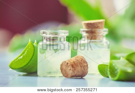 Aloe Vera Extract In A Small Bottle And Pieces On The Table. Selective Focus.