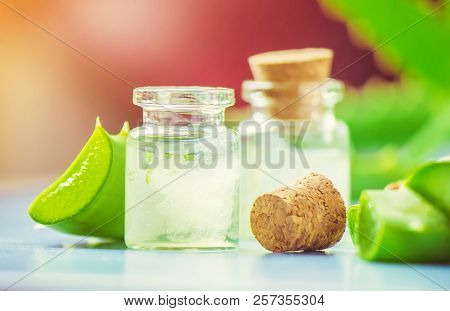 Aloe Vera Extract In A Small Bottle And Pieces On The Table. Selective Focus.