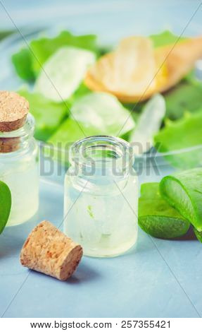 Aloe Vera Extract In A Small Bottle And Pieces On The Table. Selective Focus.