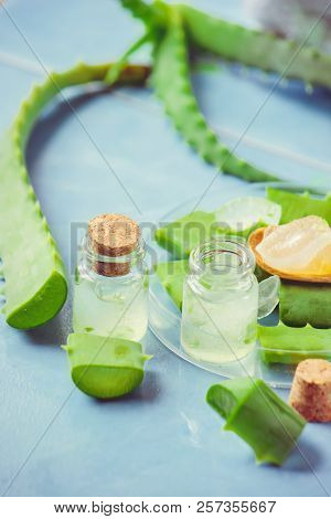 Aloe Vera Extract In A Small Bottle And Pieces On The Table. Selective Focus.