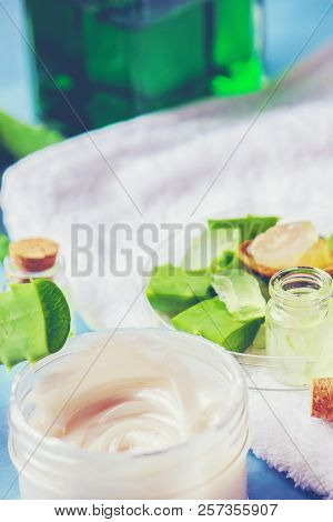 Aloe Vera Extract In A Small Bottle And Pieces On The Table. Selective Focus.