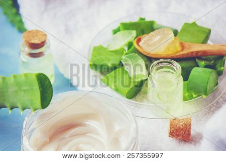 Aloe Vera Extract In A Small Bottle And Pieces On The Table. Selective Focus.