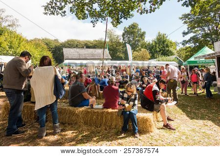 St Fagans, United Kingdom -  July 14, 2017: People Sit Eating On Hay At The Food Festival In St Faga