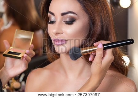 The Make-up Artist Paints Cheekbones With Rouge On The Girl's Face, Completes The Day's Make-up In T