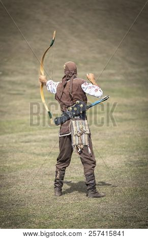 Lake Issyk-kul, Kurgyzstan, 6th September 2018: Young Nomad Shooting Arrows In The Nature During Wor