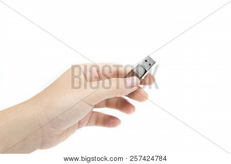 Flash Drive In Woman's Hand On White Background. Female's Hand Holding Flash Drive.