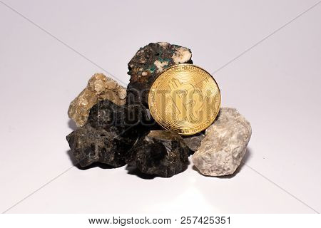 Golden Bitcoin Coin Stuck Between Stones. Cryptocurrency Mining Concept, Selective Focus.