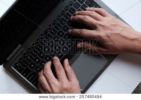 Man Hands On Laptop Typing With Strong Constrast
