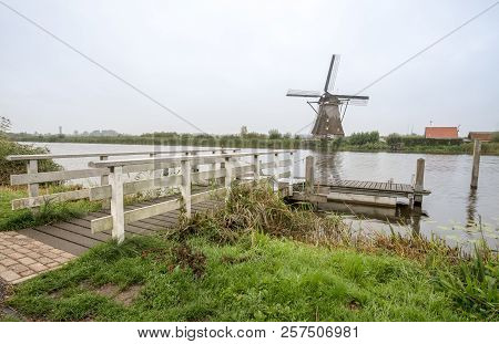 On The Water There Are Several Windmills In Kinderdijk In Holland