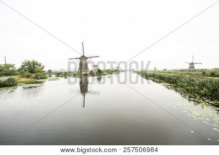 On The Water There Are Several Windmills In Kinderdijk In Holland