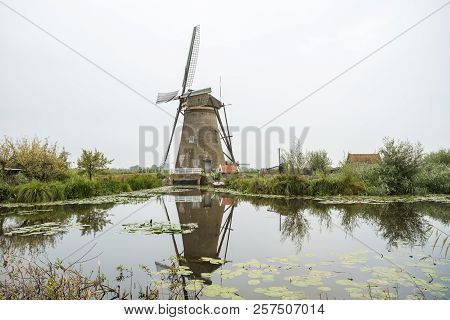 On The Water There Are Several Windmills In Kinderdijk In Holland