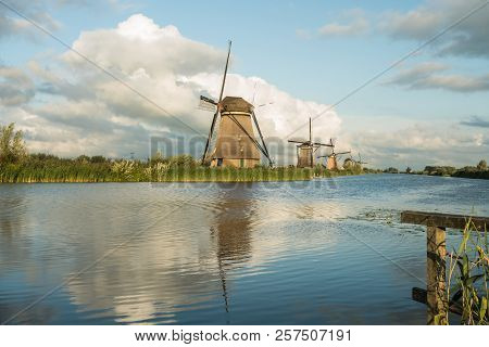 On The Water There Are Several Windmills In Kinderdijk In Holland