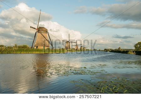 On The Water There Are Several Windmills In Kinderdijk In Holland