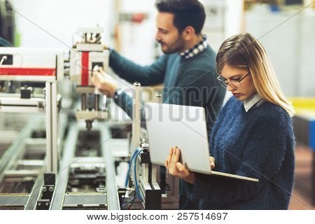 Young Attractive Students Of Mechatronics Working On Project