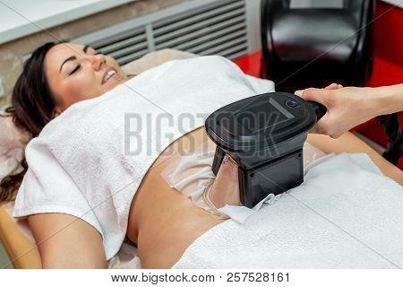 Woman Getting Cryolipolysis Fat Treatment Procedure In Professional Cosmetic Cabinet Or Spa Center