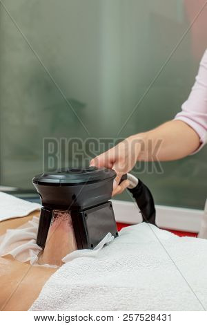 Woman Getting Cryolipolysis Fat Treatment Procedure In Professional Cosmetic Cabinet Or Spa Center