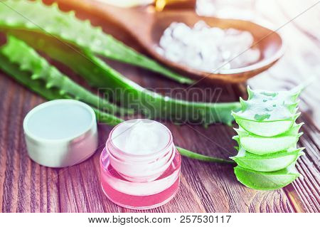 Aloe Vera Gel And Rock Salt Minerals Skin Cream On Wooden Background. Organic Skin Care And Natural 