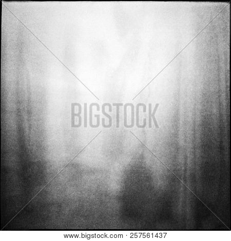 Black And White Medium Format Film Background With Grain And Light Leak. Blurry Unfocused Background