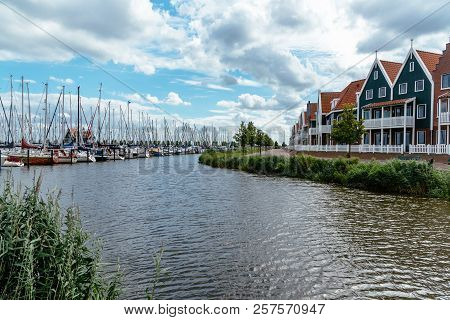 Marina Of Volendam With Traditional Hpuses And Luxury Yatchs