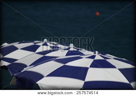 Line Of Three Umbrellas On Italian Beach