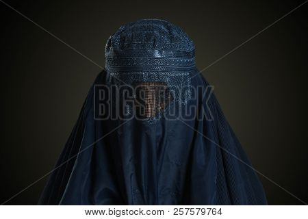 Eastern woman wearing the burqa isolated on a neutral background
