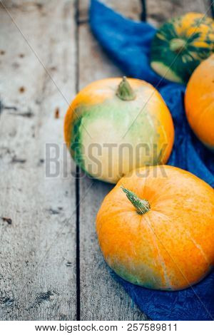Pumpkins On Wooden Background, With The Edge Of The Photo, Copyspace