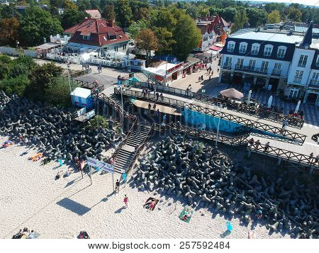 MIELNO, POLAND - 02 SEPTEMBER 2018 - Aerial view on sunny beach with tourists at baltic sea on Mielno city