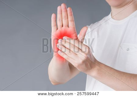 Pain In Hand, Carpal Tunnel Syndrome On Gray Background, Painful Area Highlighted In Red