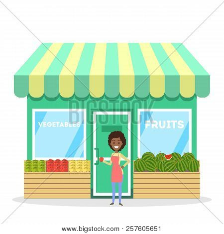 Female Seller Standing In Front Of Fruit And Vegetable Store