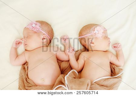 Sweet Twins Girls  Are Sleeping On The Bed
