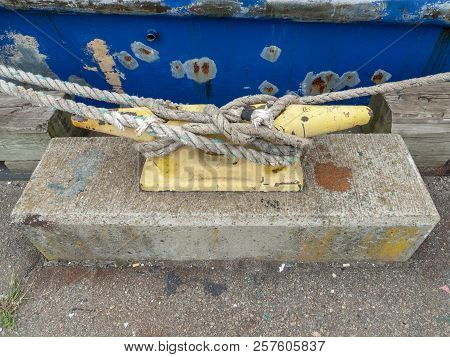 Lines Holding Fishing Vessel To Large Cleat Wharfside