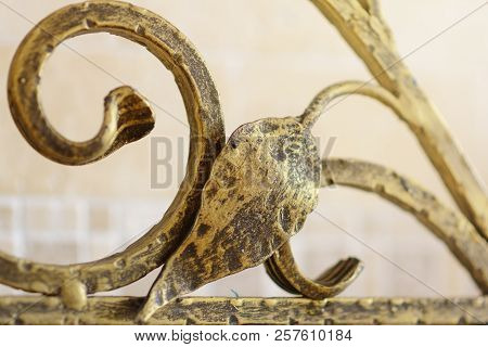 Wrought Iron Ornamental Grate For The Fireplace. Decorative Detail Of Metal Lattice For Interior.
