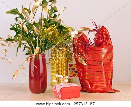 Luxury Packed Gifts With Mistletoe In Red Vase