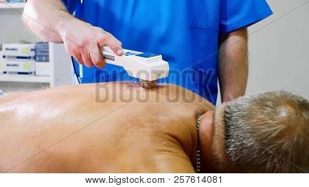 Senior Male Patient Receive Electrostatic Therapy Procedure On His Back.